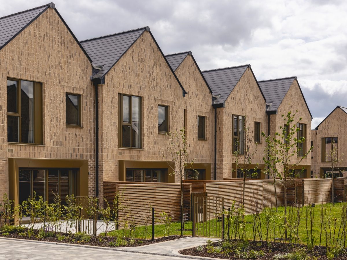 Completed terraces at Present Made, Eddington in Cambridge, part of the 373-home single-family build-to-rent scheme that Apache Capital and Nuveen refinanced with a £125m, two-year facility from United Overseas Bank, illustrating the homes moving from construction finance into a post-completion loan.