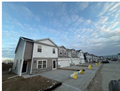 Exterior view of the Townhomes at Magnolia Heights in Urbandale, showing the two‑story rental townhome units that Tricap Investments acquired as part of the transaction financed by Associated Bank’s $17.7M term loan.