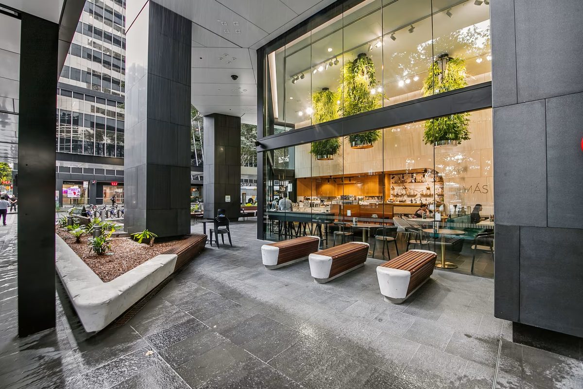 The refurbished entrance and café frontage at 66 Eagle Street, also known as Central Plaza 2, illustrate the Brisbane office tower sold by Deka Immobilien to GPT for approximately A$380 million.