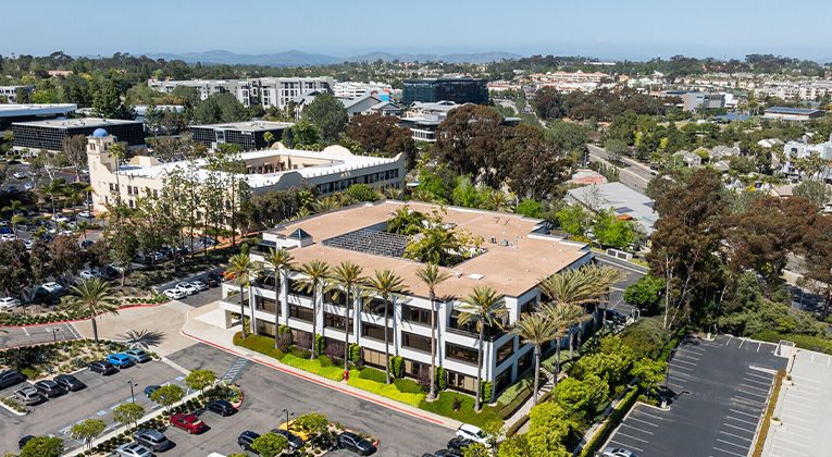 Aerial view of office buildings in Del Mar Heights illustrating the submarket Hughes Marino says has seen asking rents jump 15–20% despite sustained 19–22% availability, the context for the firm’s tenant warning.