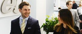 eQ Asset Management staff or representatives in an office setting, illustrating the firm behind the announced €915 million refinancing across its Social Infrastructure and Commercial Properties funds.