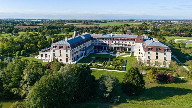 An aerial view of Crowne Plaza Paris Marne-la-Vallée in Magny-le-Hongre, highlighting the landscaped grounds and large-scale hospitality property opened by InterContinental Hotels Group.