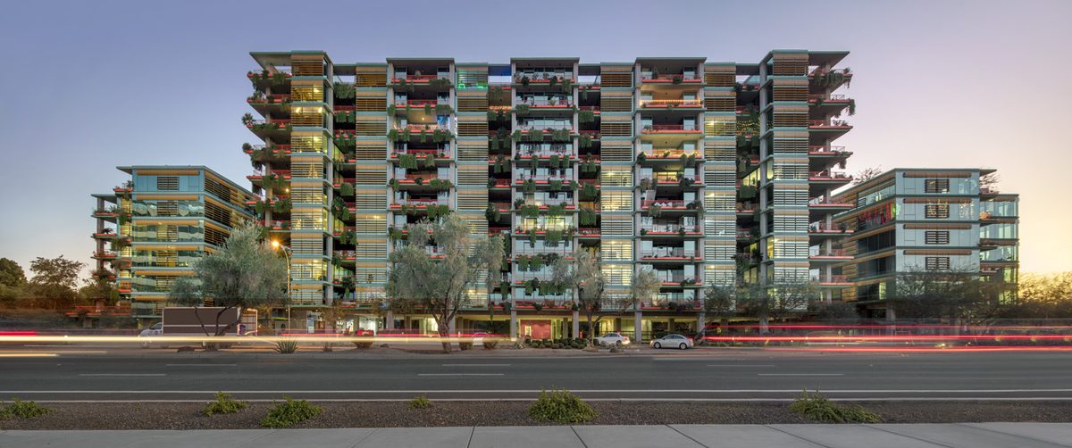 Optima McDowell Mountain exterior, an example of high-density condominium architecture that illustrates the style and scale DMB Associates is proposing with 350 for‑sale condos in the amended One Scottsdale plan.