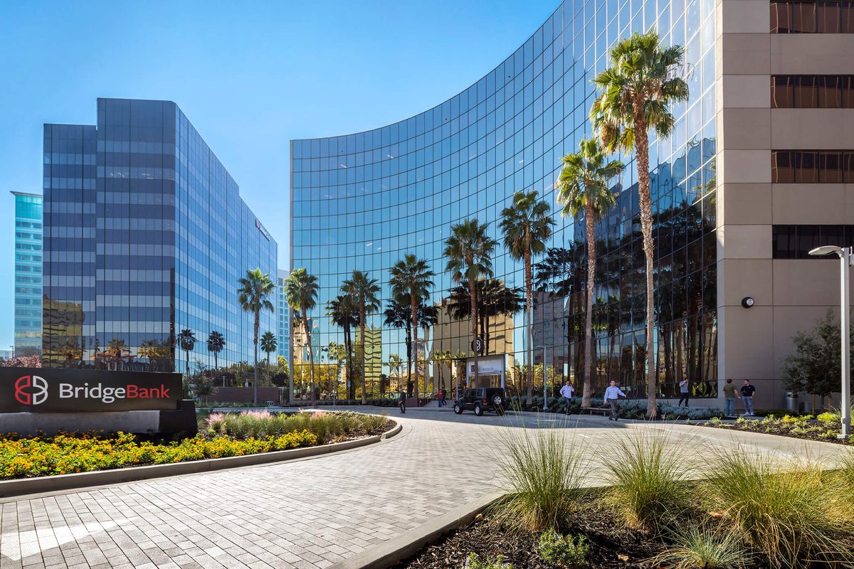 The Almaden office campus in downtown San Jose, pictured with its landscaped entrance and glass office buildings, was acquired by SFF Realty Partners from KBS for $82 million.