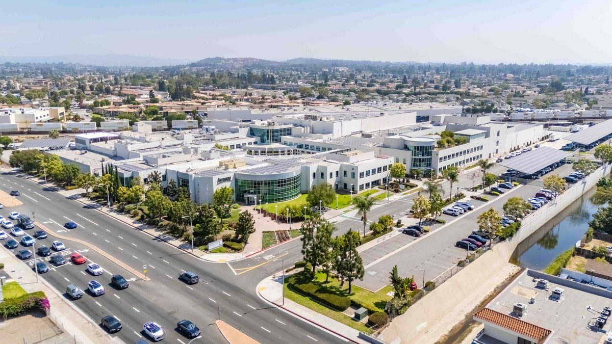 Aerial view of the industrial campus at 5600 Beach Boulevard in Buena Park, the former Amway site that Shopoff Realty Investments plans to redevelop into a 281-unit residential community, showing the scale and street frontage that inform the project design.