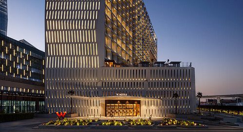 The illuminated façade and main entrance of W Riyadh – KAFD, the 210-room W Hotels property in Riyadh's King Abdullah Financial District that marks the brand's first opening in Saudi Arabia.