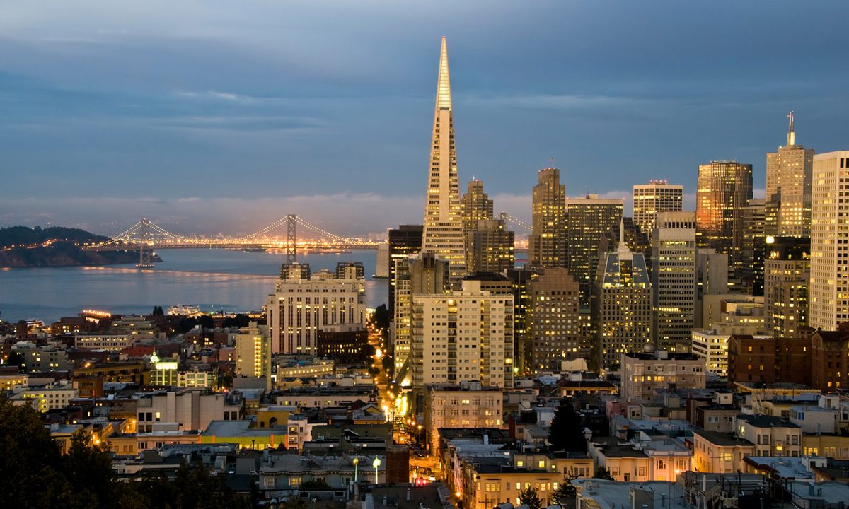 San Francisco skyline at dusk, illustrating the constrained multifamily market in the city that Kidder Mathews says is accelerating as AI hiring increases local housing demand.